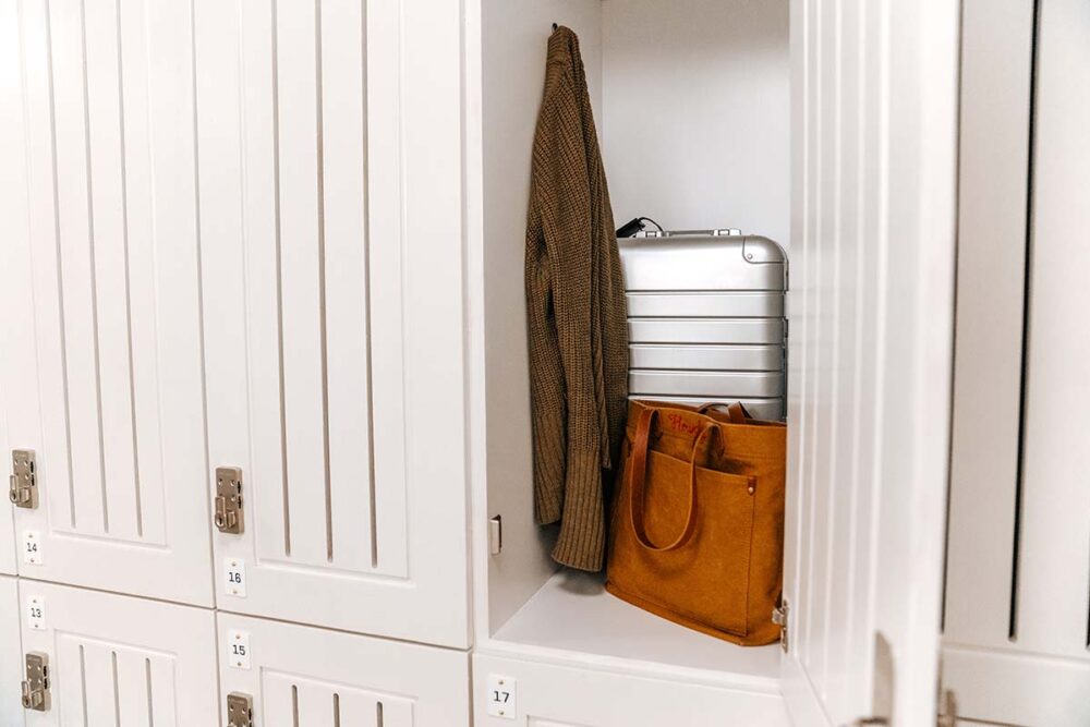 Storage locker with clothes and suitcase