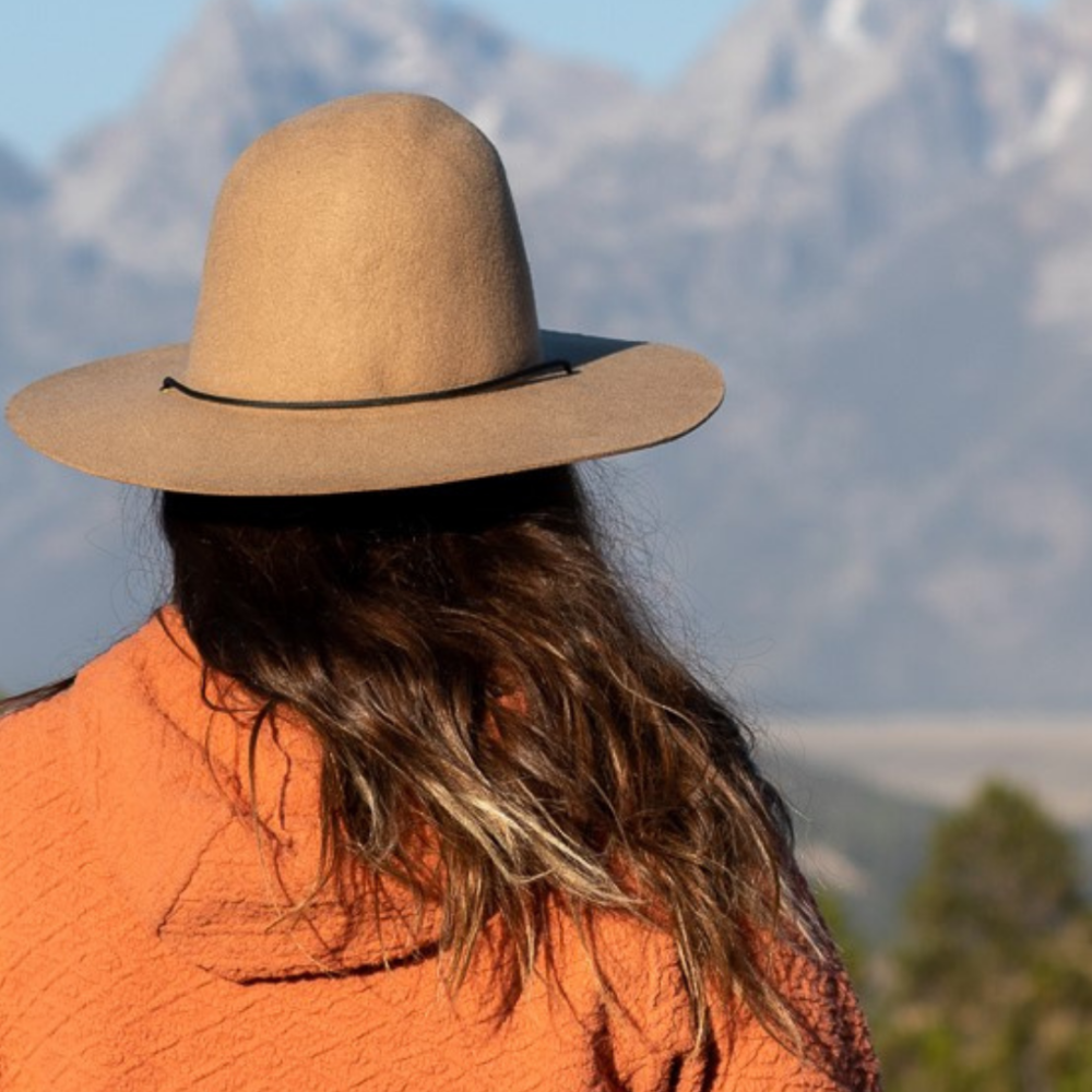 lady in hat looking at mountain range