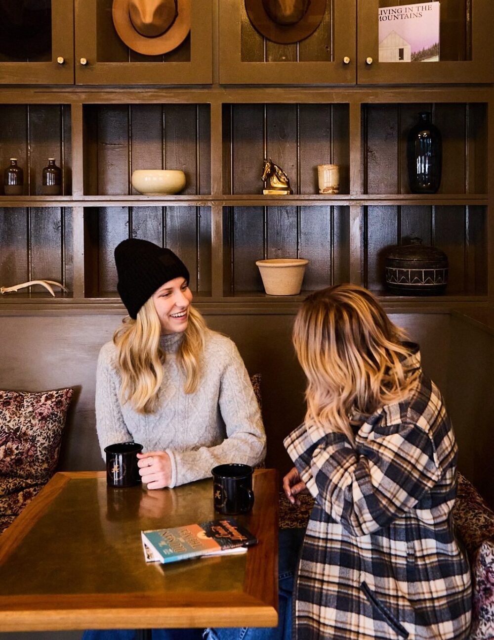 Two women having coffee and reading in Anvil Hotel lobby.