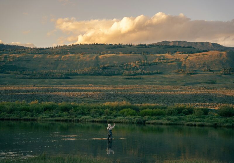 A man fly fishing in a river in Wyoming.
