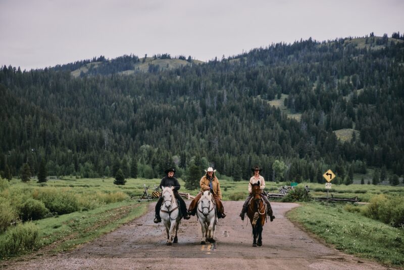 Three women horseback riding in Wyoming.
